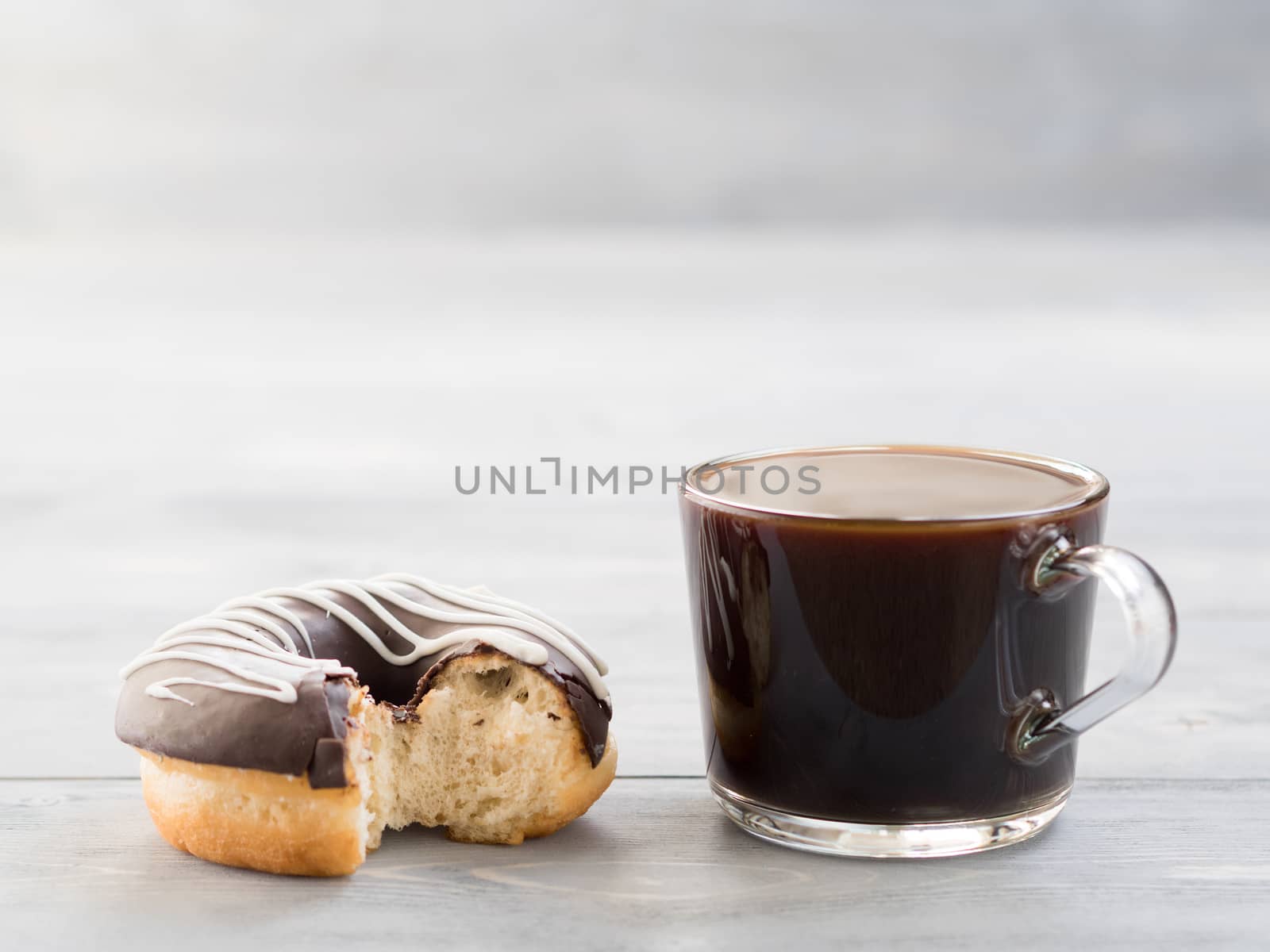 donuts and coffee on gray wooden background , copy space by fascinadora