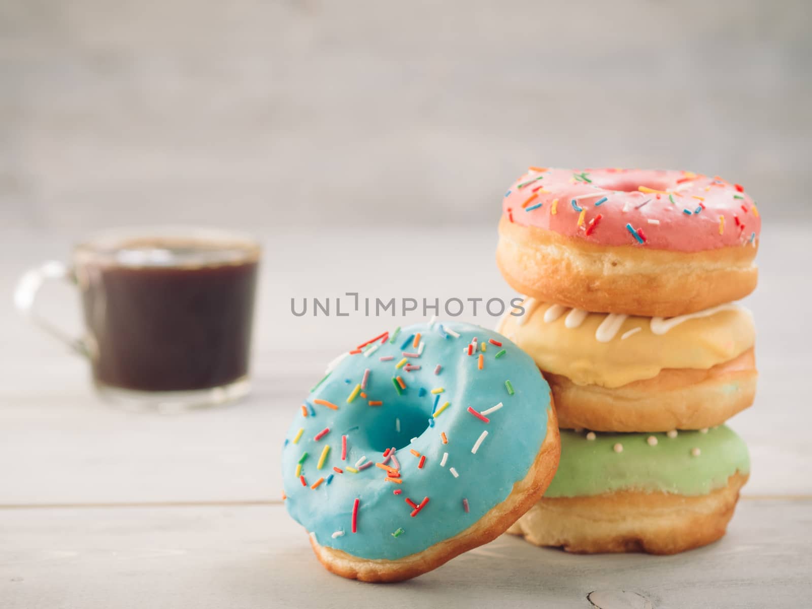 donuts and coffee on blue background , copy space by fascinadora