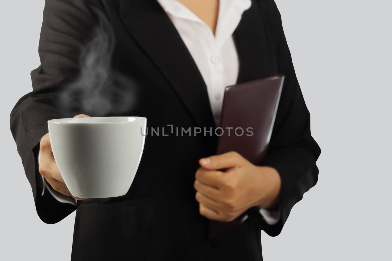 Coffee break, Young businesswoman enjoying in a cup of coffee isolated on gray background, clipping path.