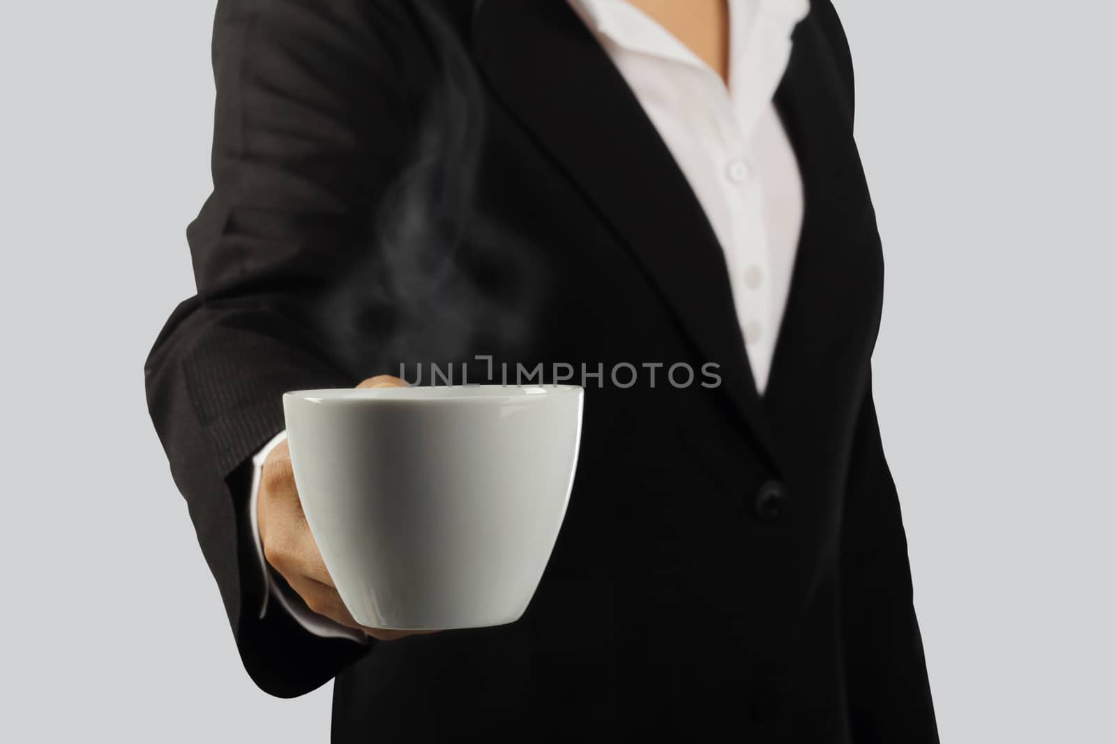 Coffee break, Young businesswoman enjoying in a cup of coffee isolated on gray background, clipping path.