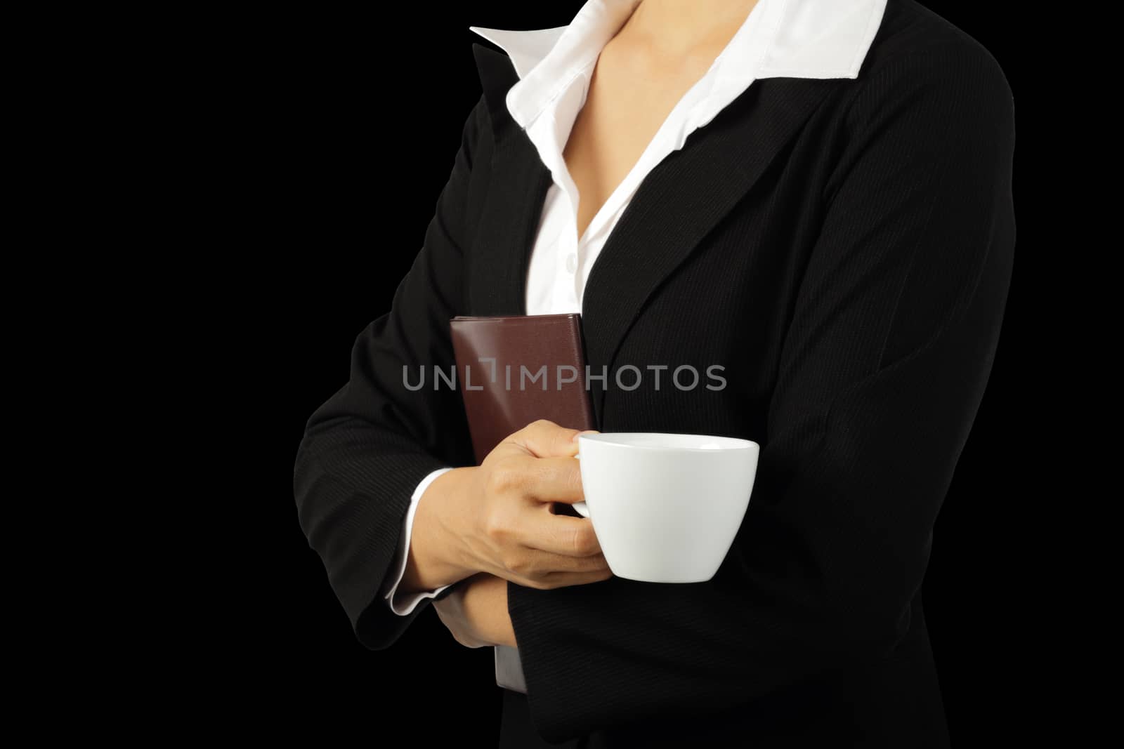 Coffee break, Young businesswoman enjoying in a cup of coffee isolated on black background, clipping path.