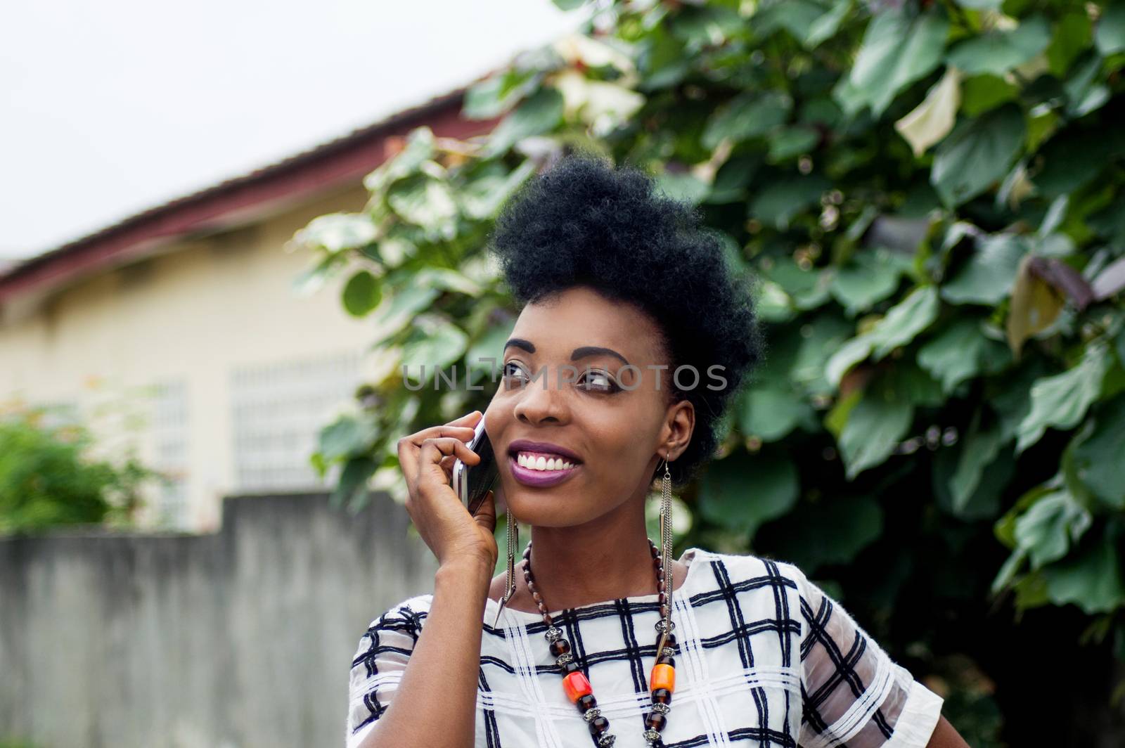 portrait of young woman standing outside and communicating with a beautiful smile.
