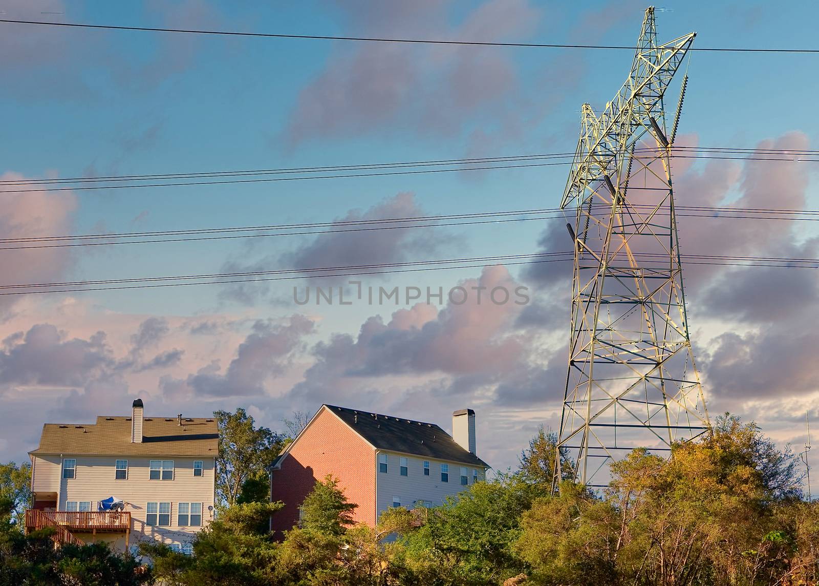 High power electrical tower and lines over expensive houses