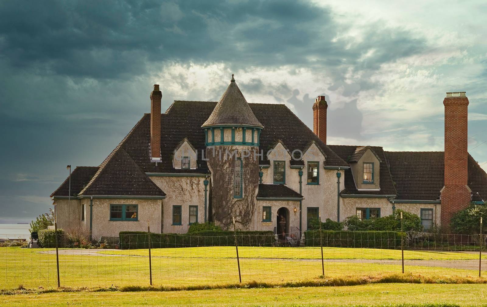 A large on estate on the coast with clouds in the background