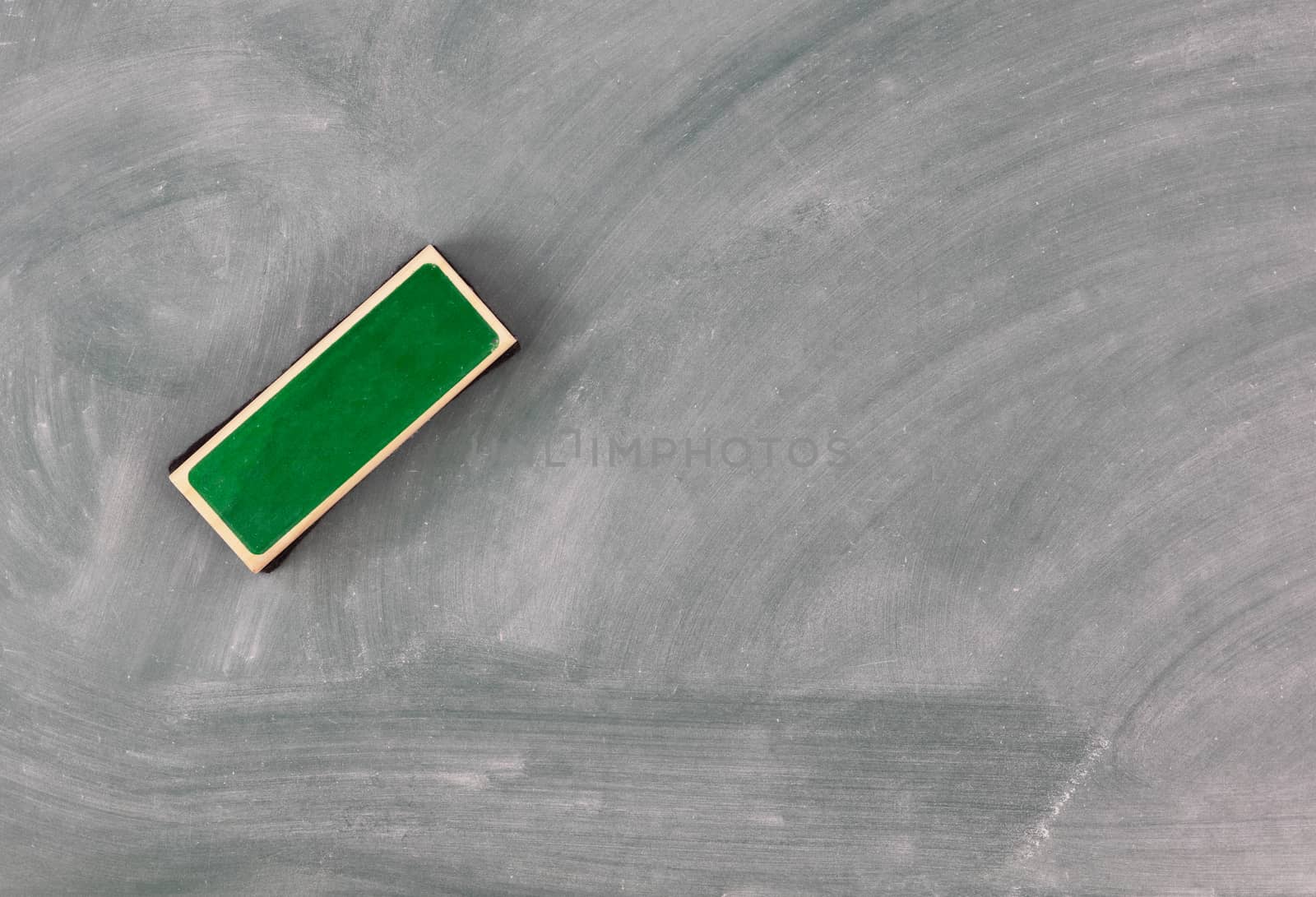 Back to school concept with green erased chalkboard and eraser