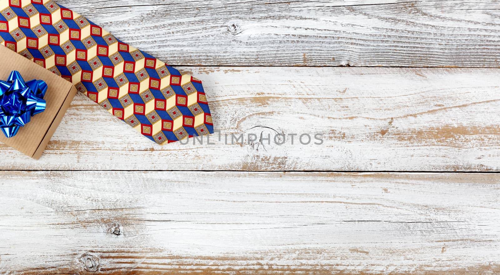 Happy fathers day concept with gift box and dress tie on white wooden background 