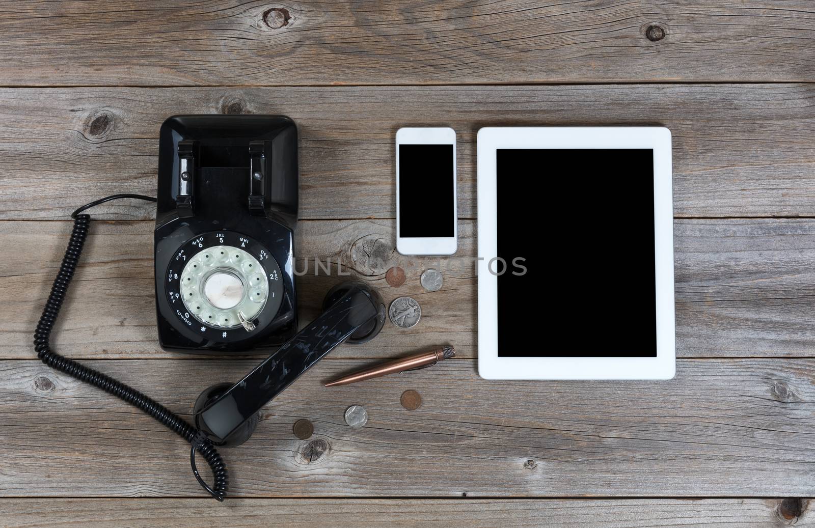 Obsolete and modern communication devices on rustic wooden board by tab1962