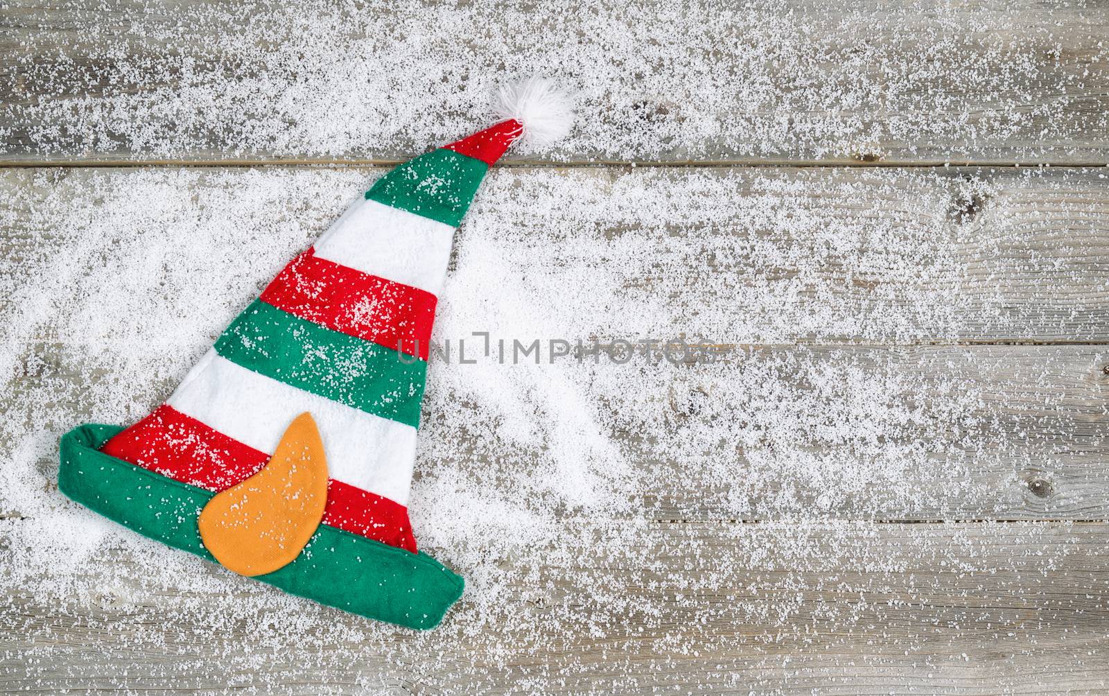 Christmas Elf Stocking on rustic wood with snow  by tab1962