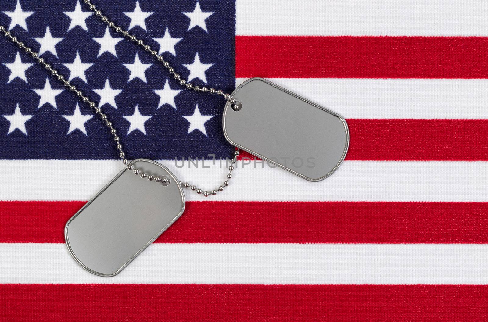 Close up of military identification tags on USA Flag  by tab1962