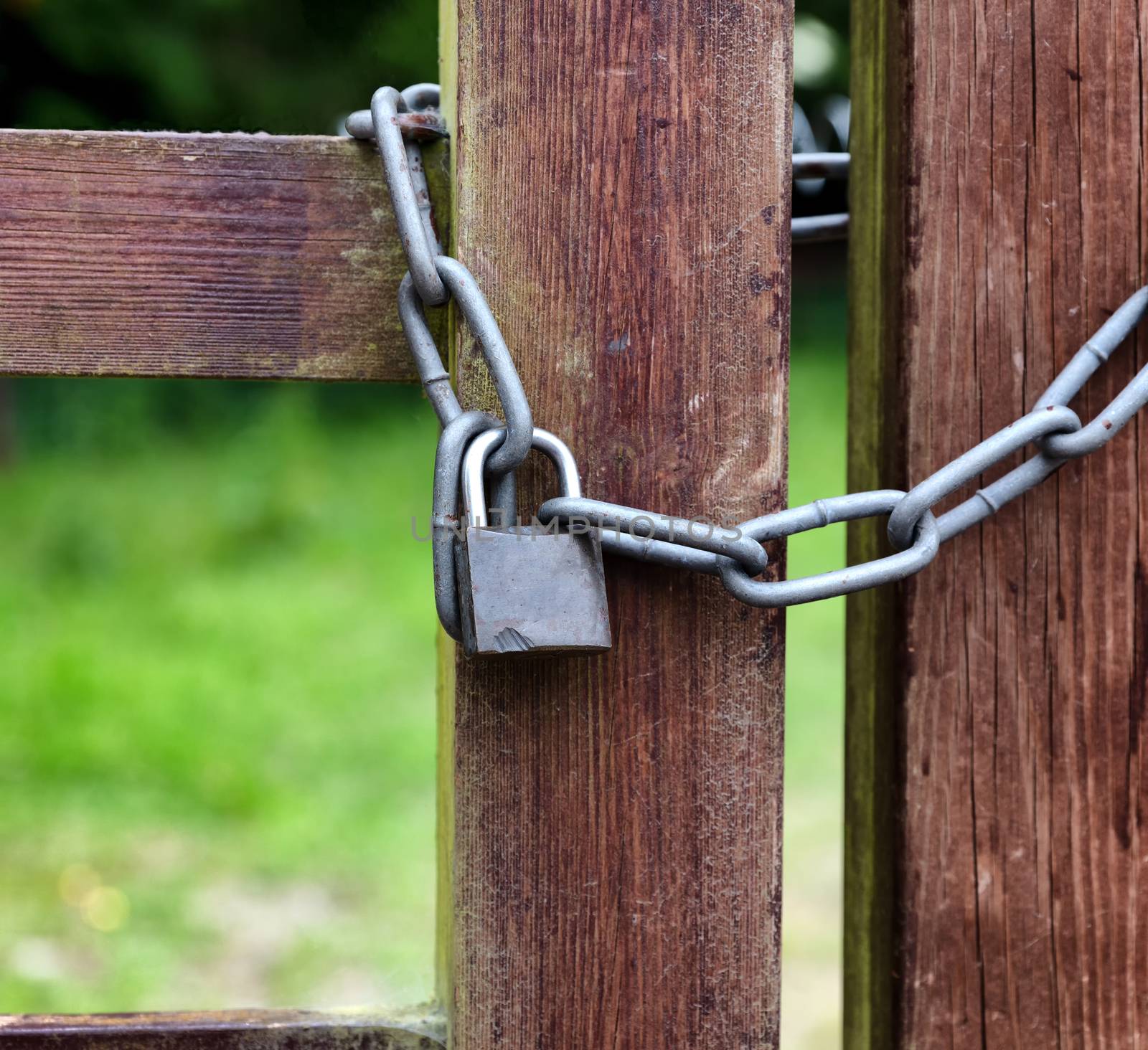 Key lock and thick chain on fence post