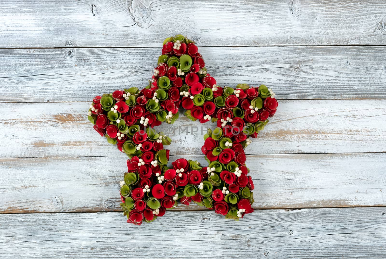 Christmas wreath made of real wooden flowers on white vintage wood