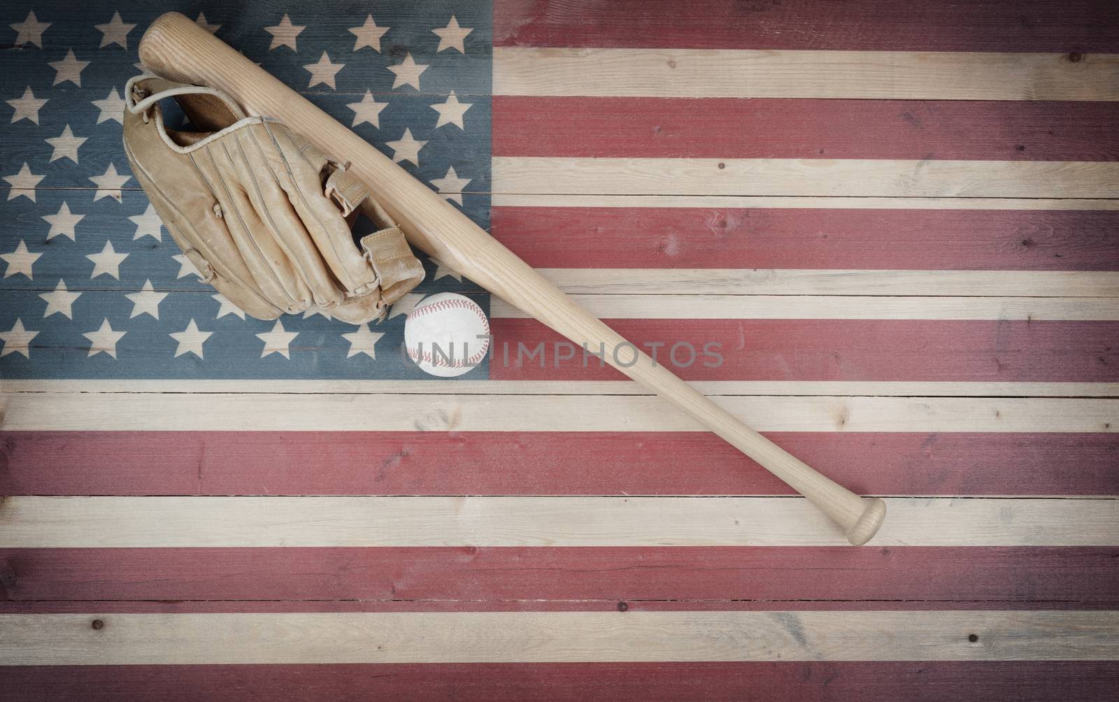 Old American baseball equipment on vintage United States wooden flag