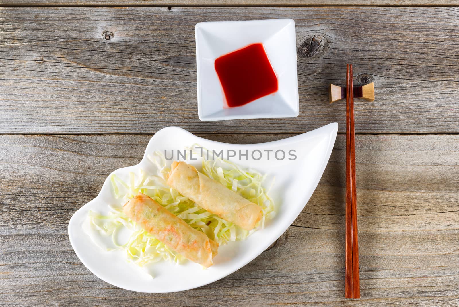 Fried Chinese spring rolls and sweet dipping sauce in white bowl by tab1962