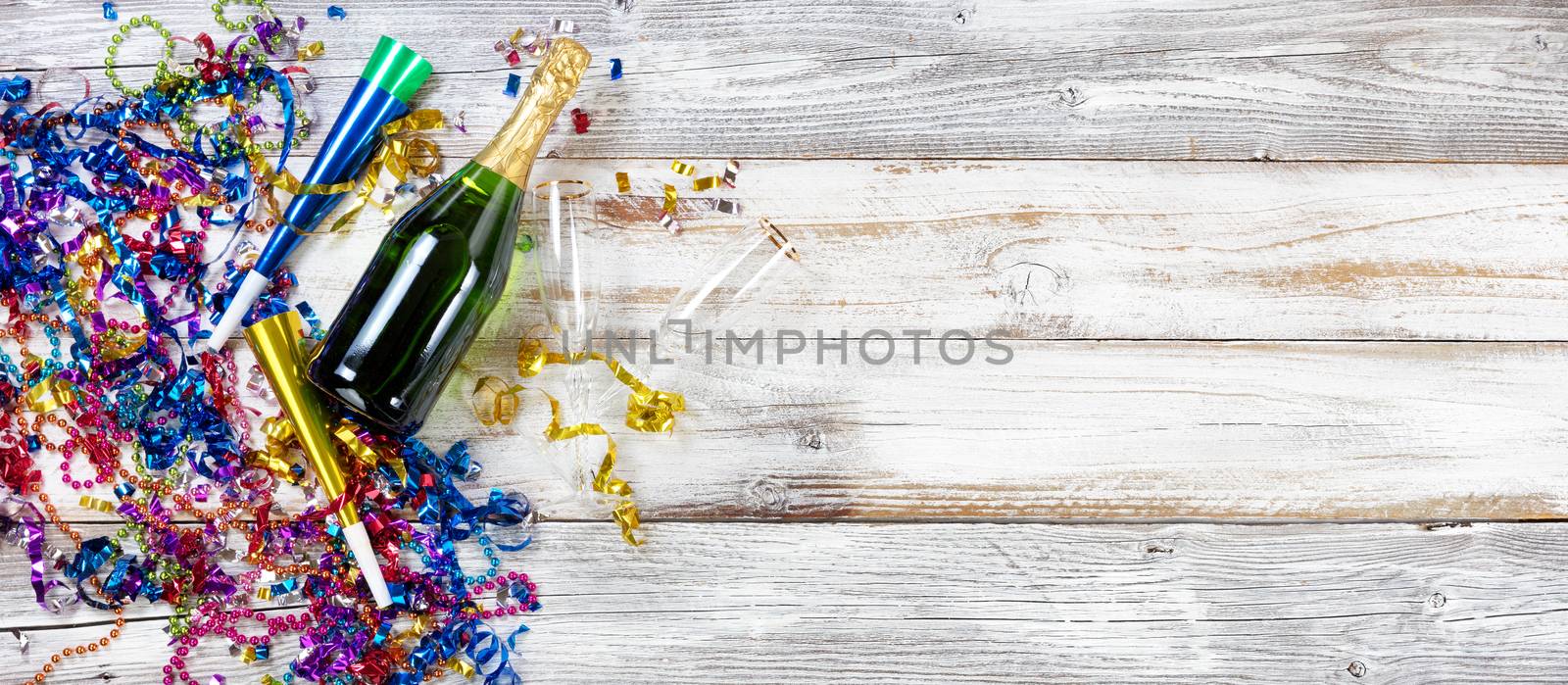 New Year party decorations and champagne on rustic white wood by tab1962