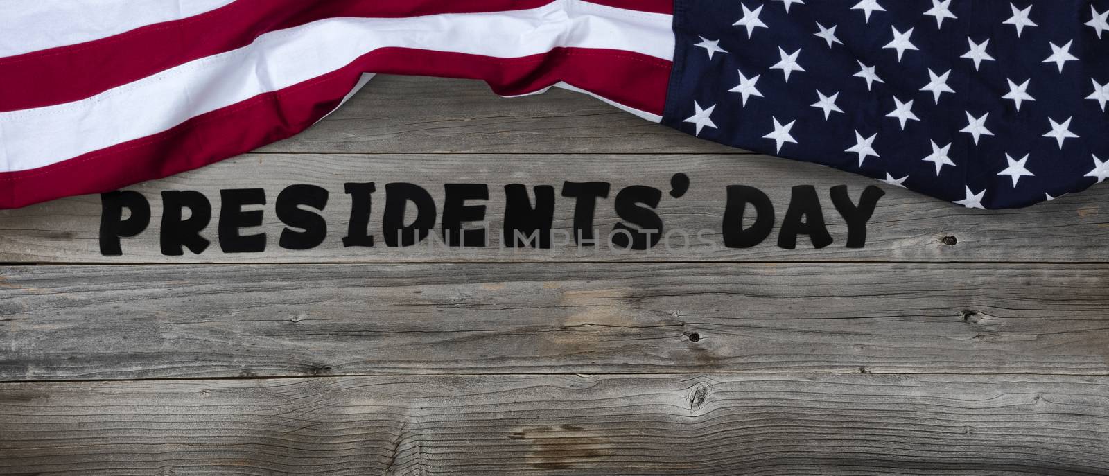 Presidents day in large text letters on rustic wood with US flag by tab1962