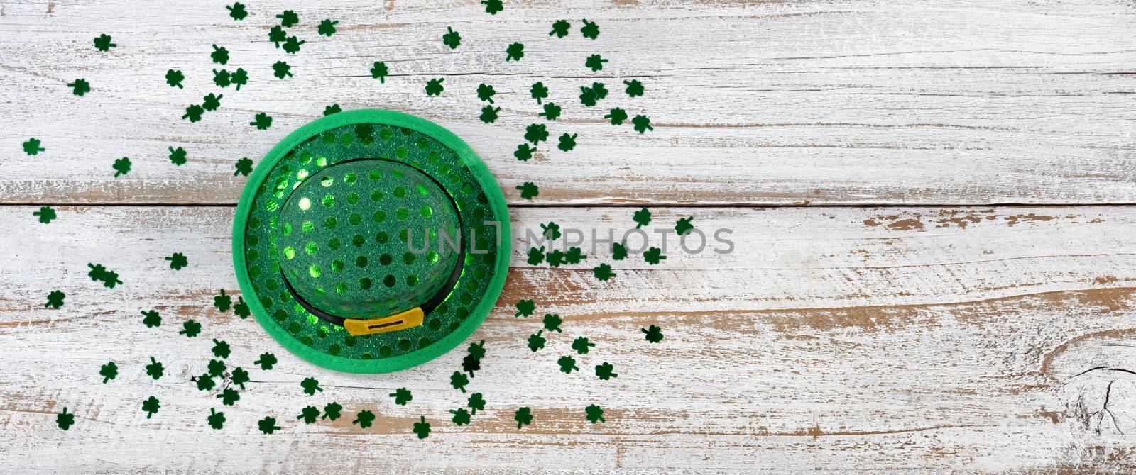 St Patricks Hat and Clovers on rustic wooden background by tab1962