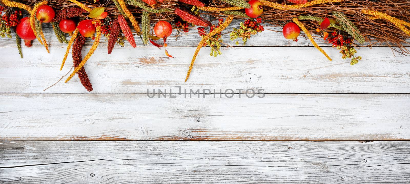 Thanksgiving decorations on top portion of white rustic wood 