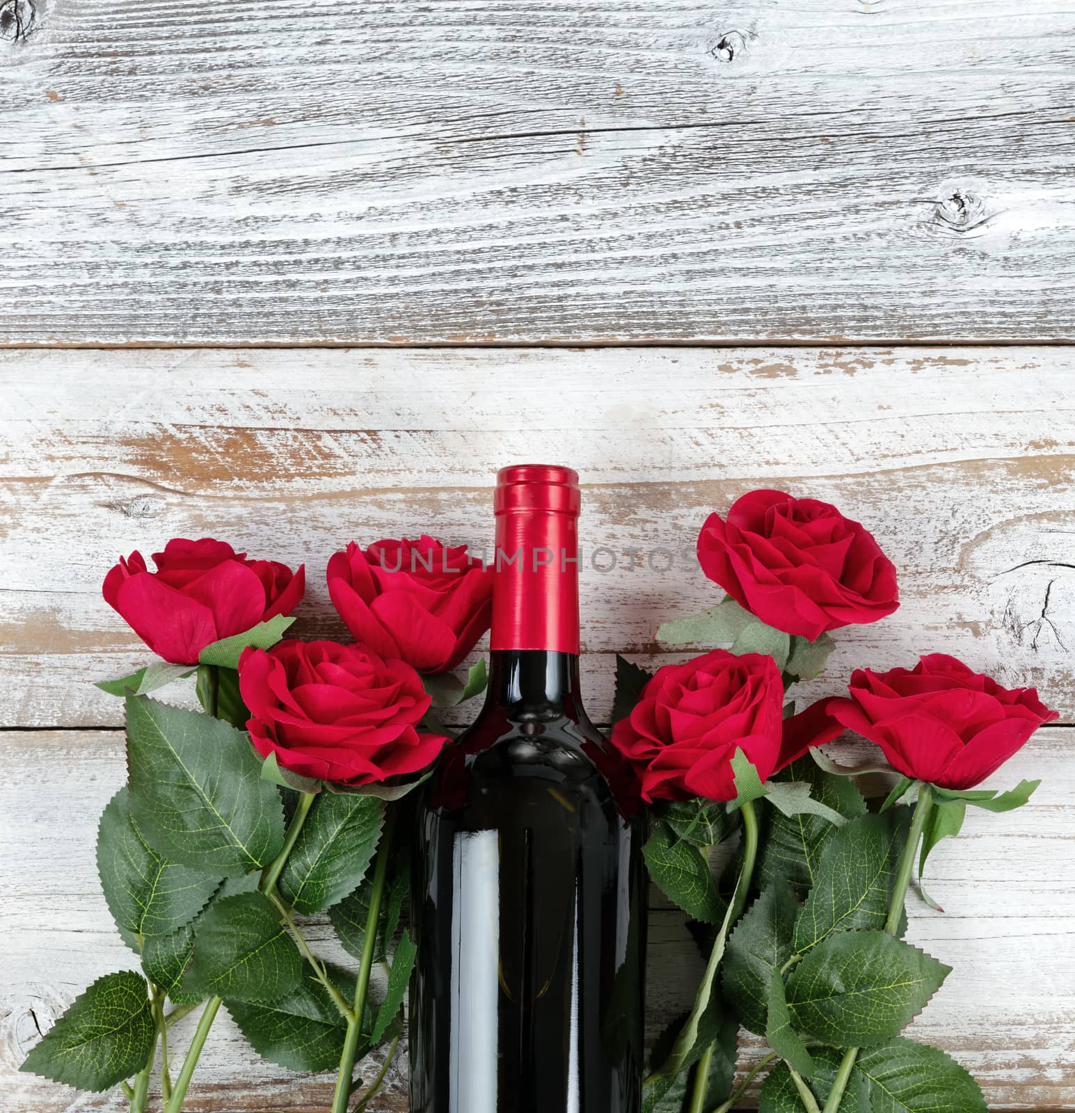 Valentines Day celebration with red wine and roses on bottom of  by tab1962