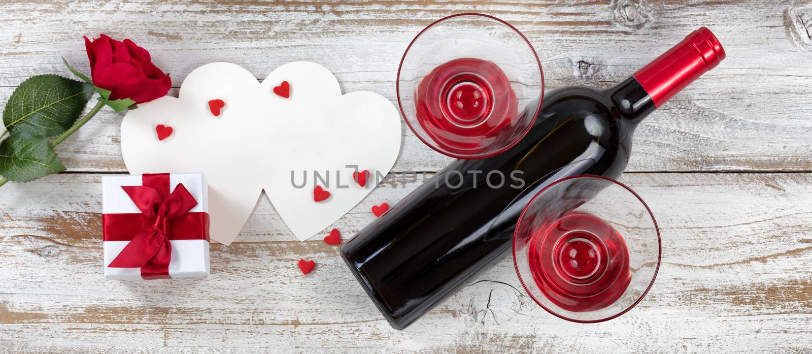 Valentines wine with gifts on rustic wooden background by tab1962