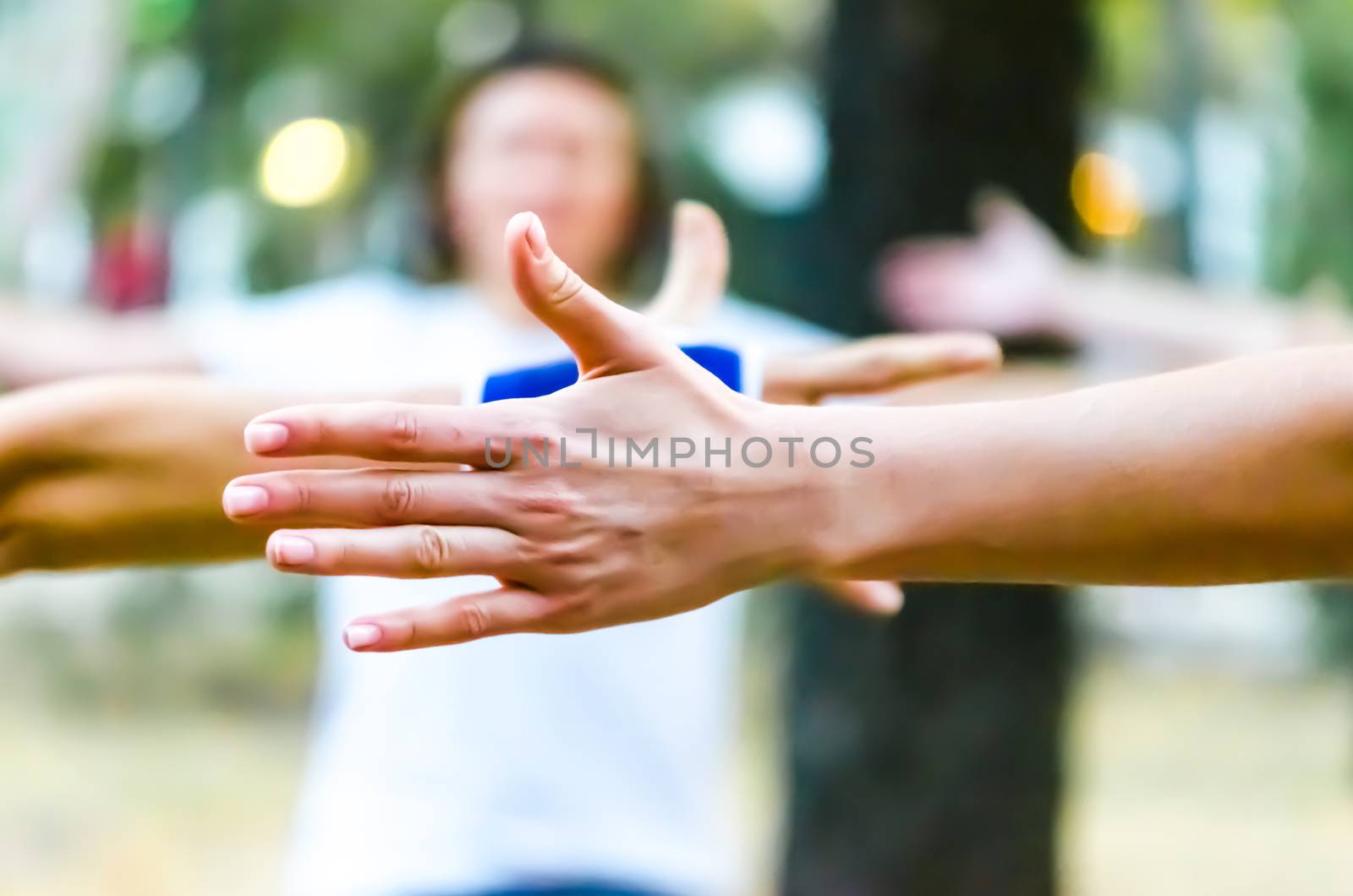 hands of people are raised up yoga in the park by Gera8th