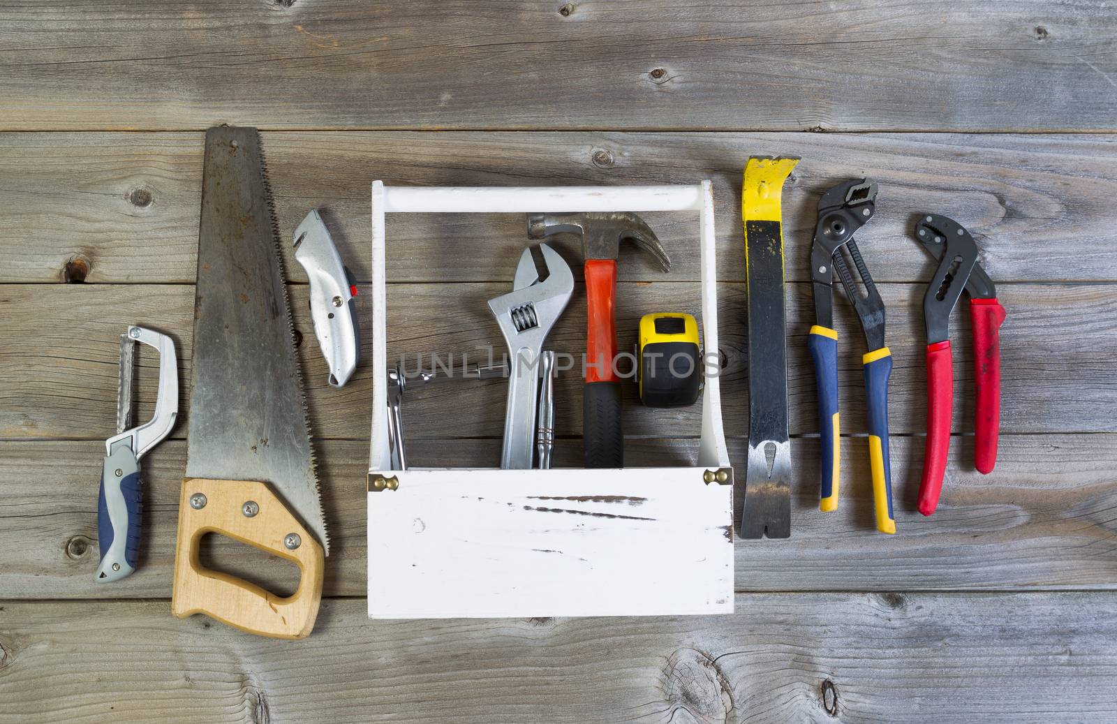 Over head view of basic home repair tools and holder on rustic wooden boards