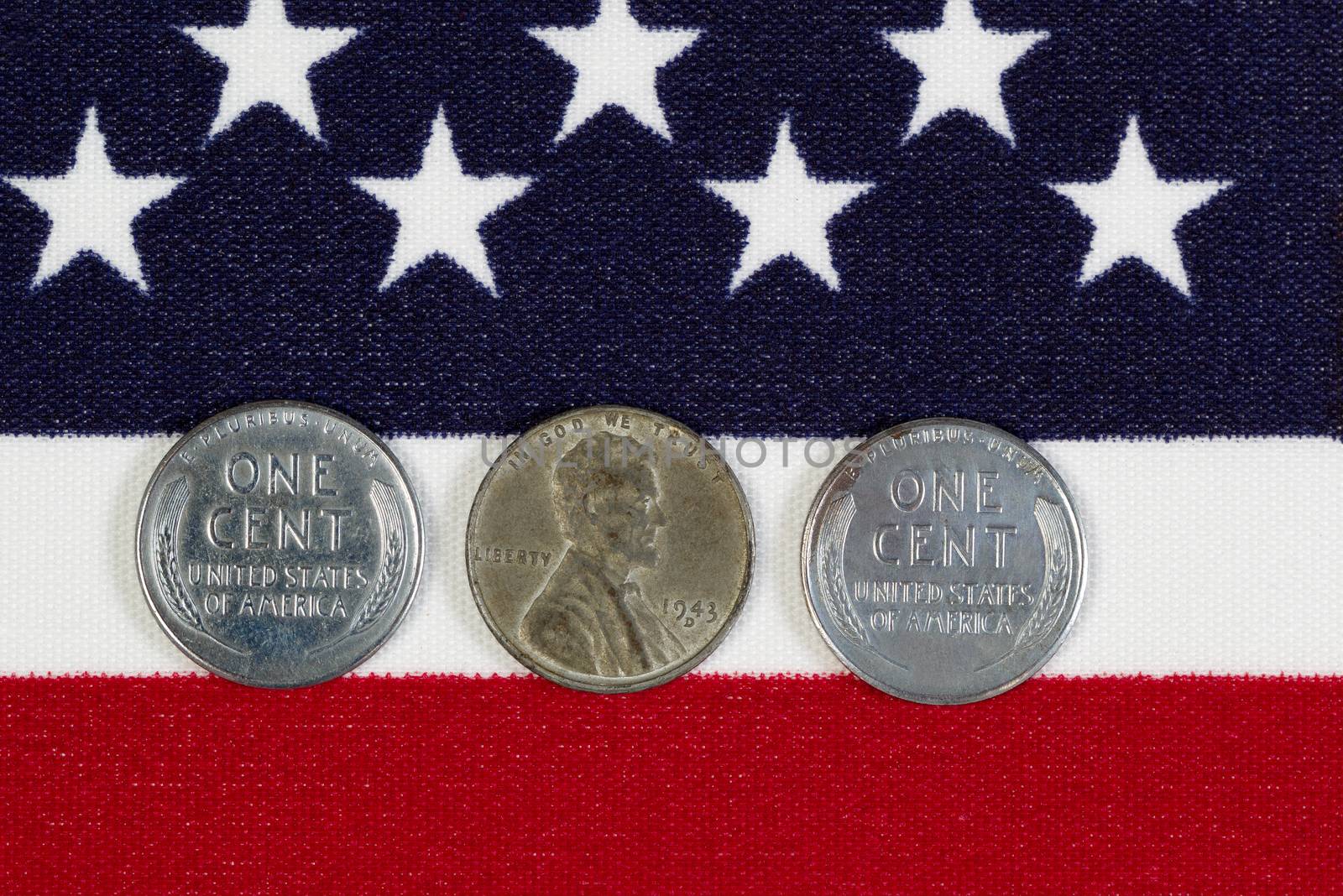 Closeup view of United States One Cent Pieces, original World War II dates, placed on American Flag 