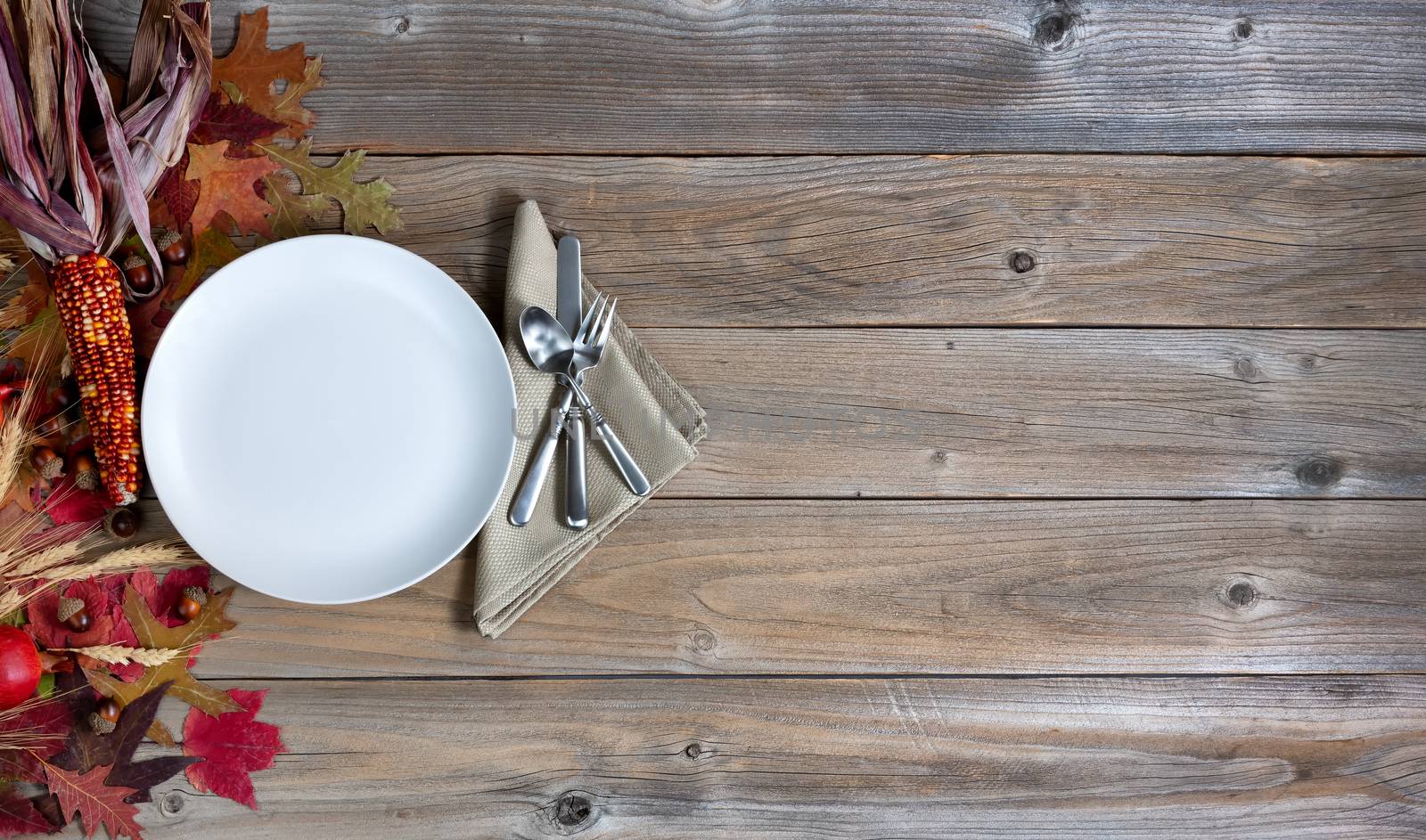 Thanksgiving holiday dinner setting on rustic wood