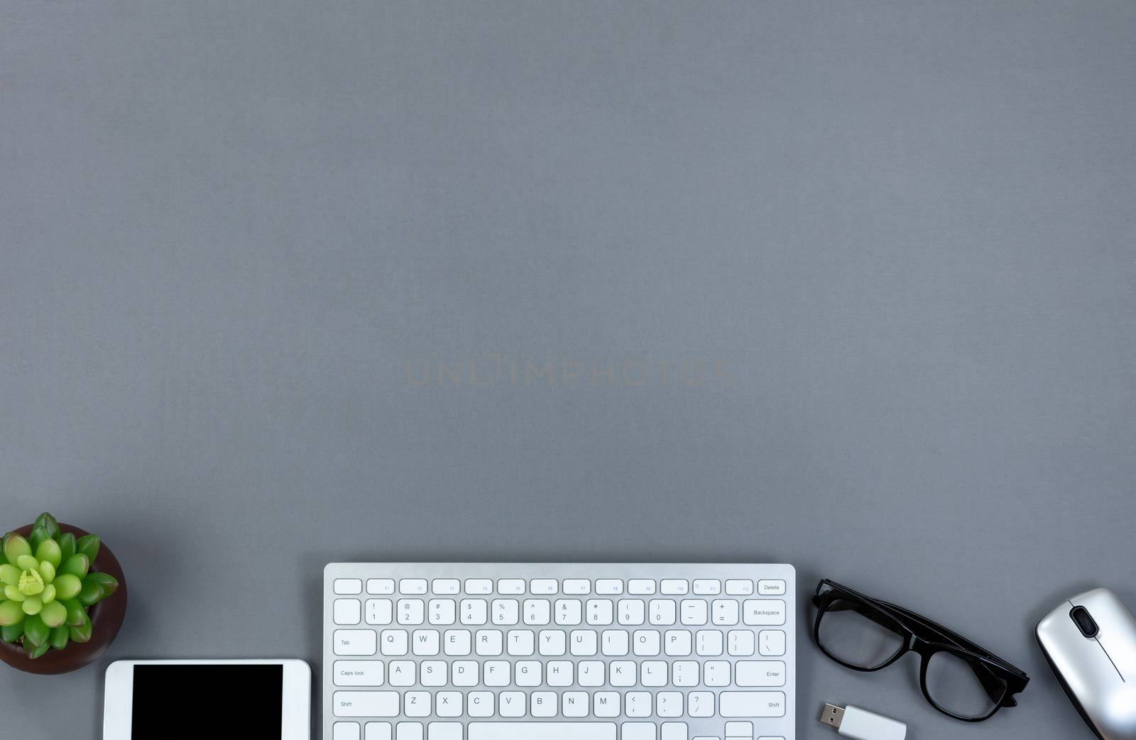 Grey office desktop with technology and copy space