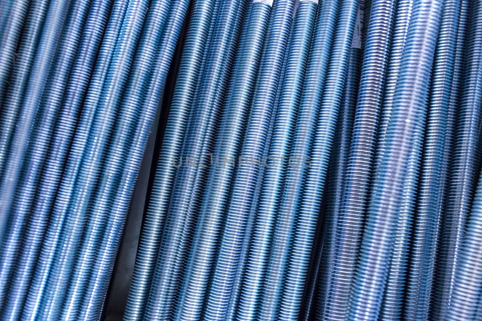 threaded metal rods. technological background or texture. A number of threaded steel rods, may be used as background