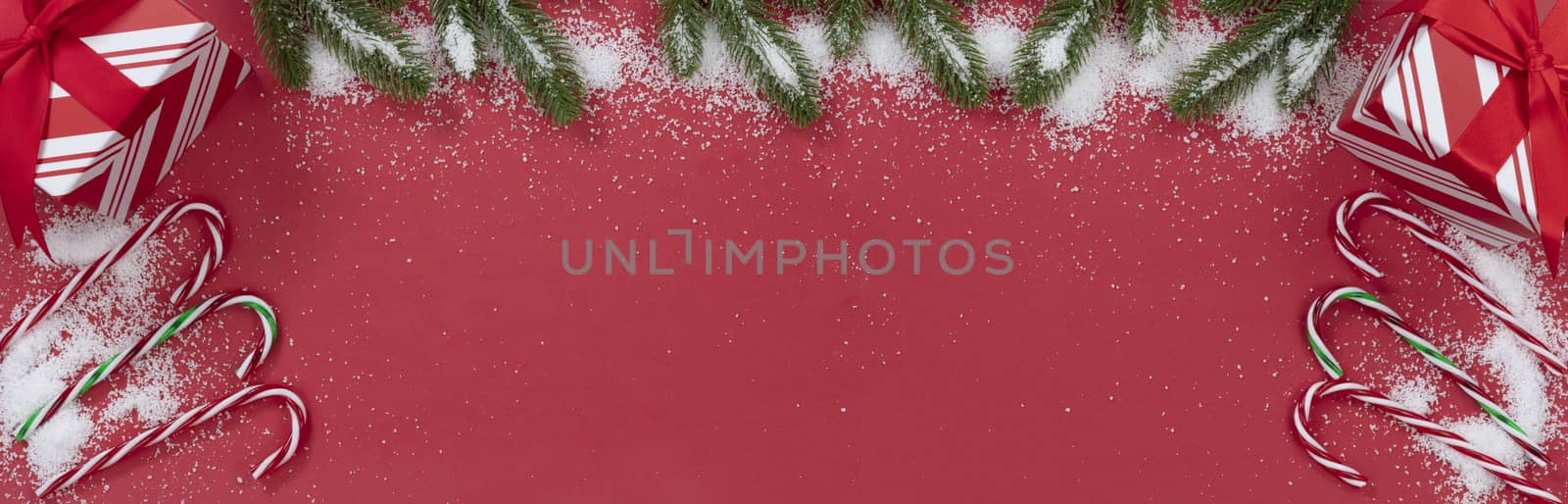 Seasonal Christmas decorations on red background with snow  