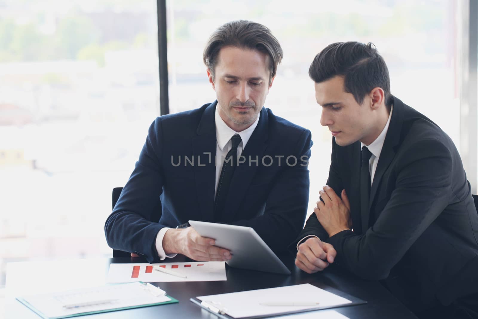 Two business men looking at tablet by ALotOfPeople