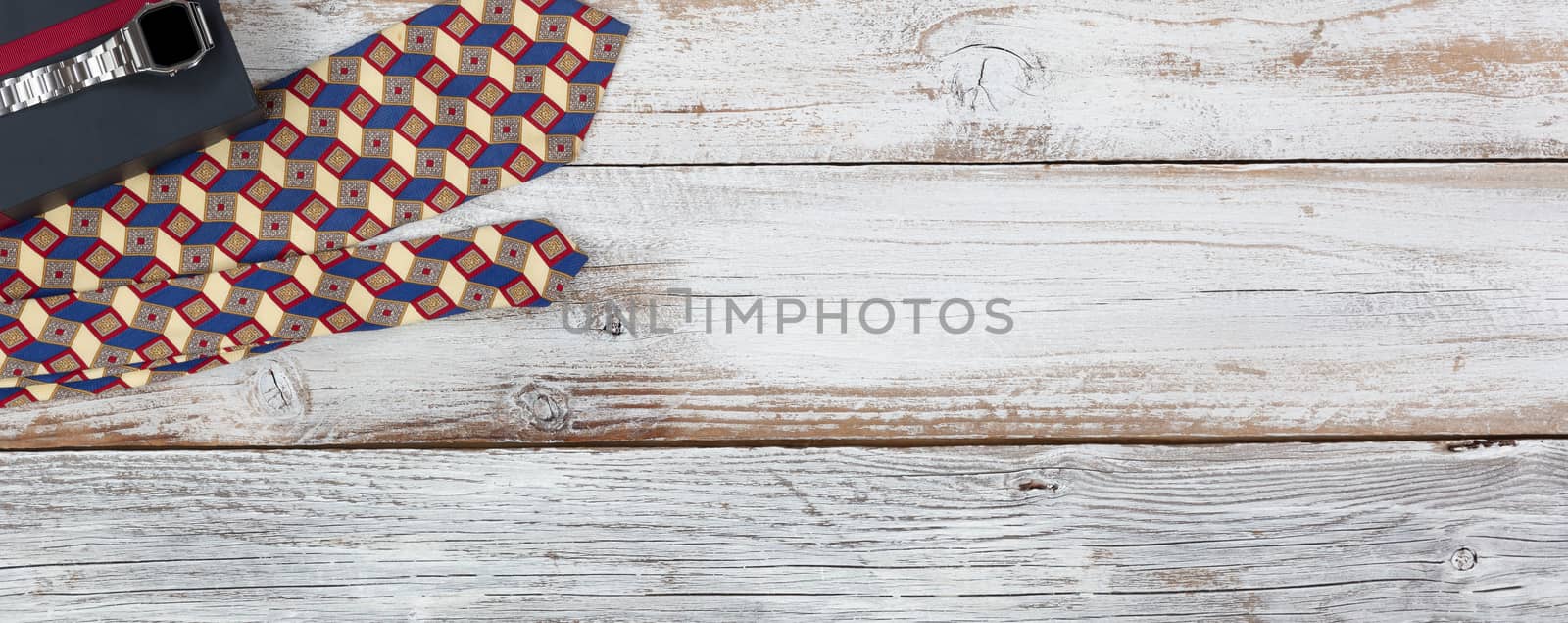 Happy fathers day concept with gift box, watch and dress tie on white wooden background 