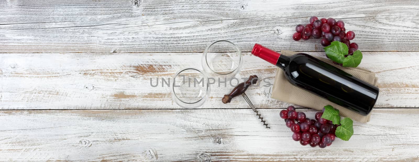Preparing to drink red wine on weathered table  by tab1962