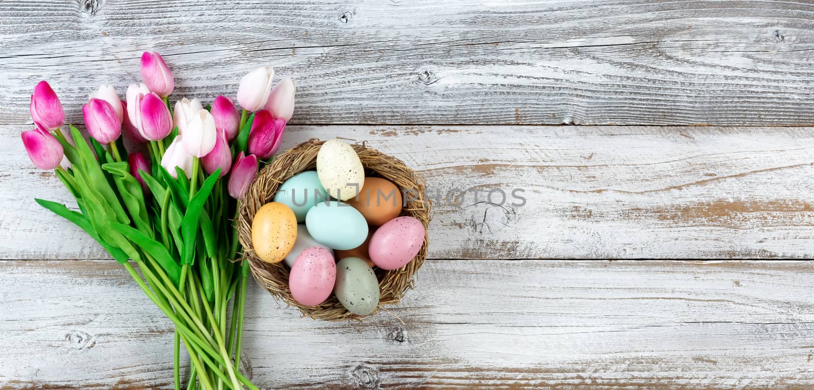 Bouquet of tulips and colorful eggs for Easter on white wood by tab1962