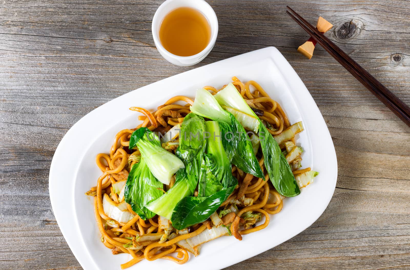 Chinese spicy noodle and vegetable dish with green tea by tab1962
