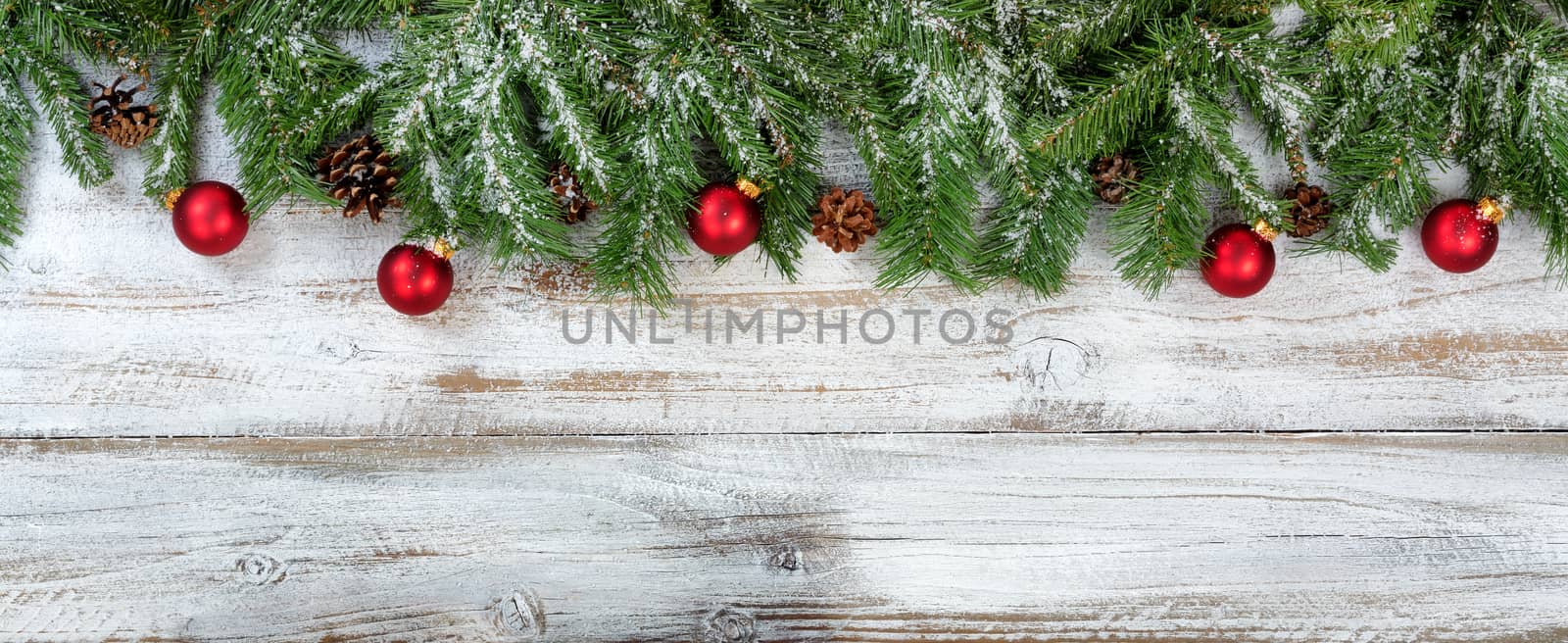 Christmas branches and ornaments on rustic white wooden backgrou by tab1962