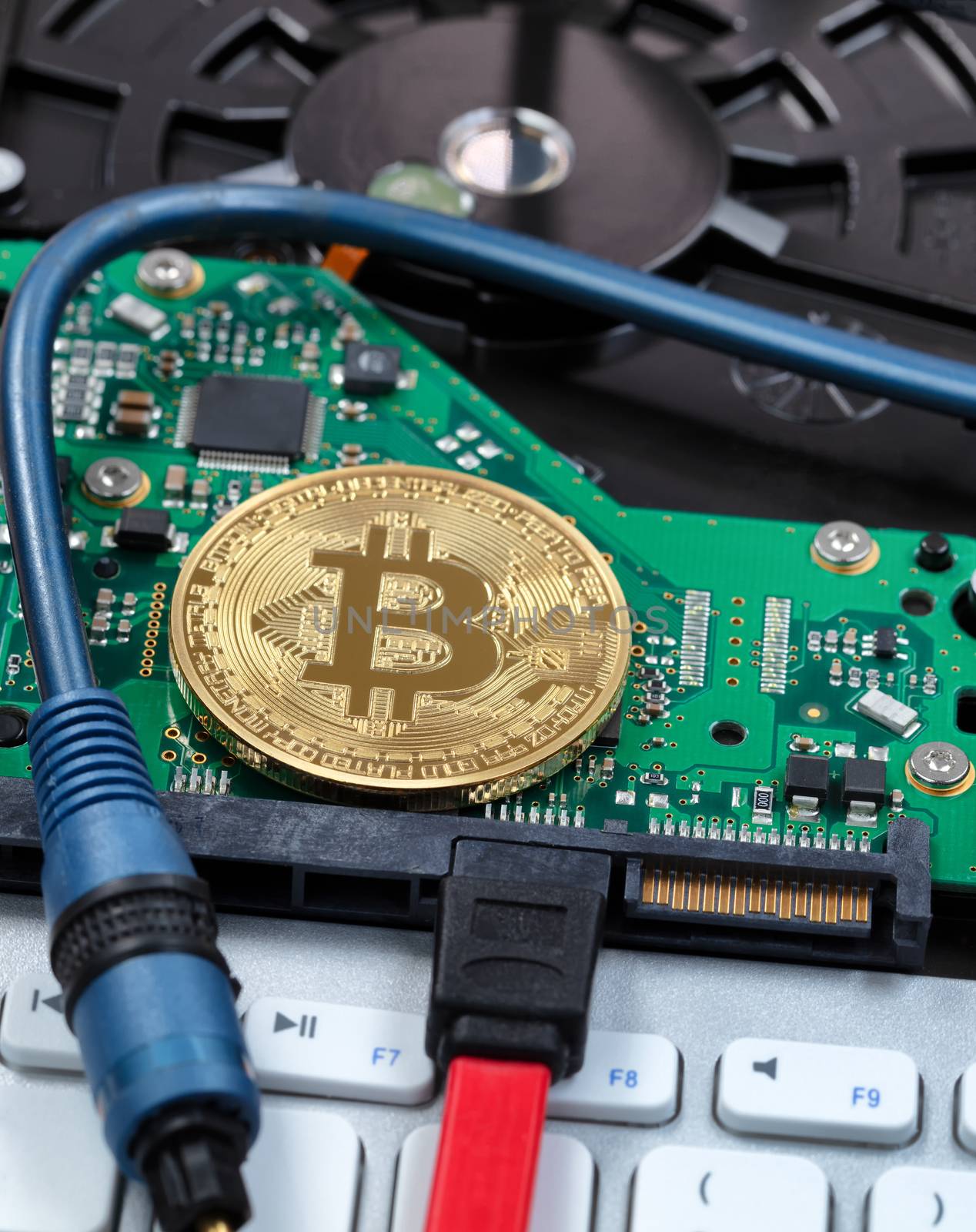 Close up of a single bitcoin on circuit board of computer with f by tab1962