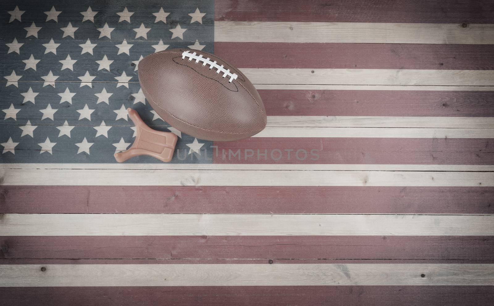 American football and kick tee on vintage United States wooden flag