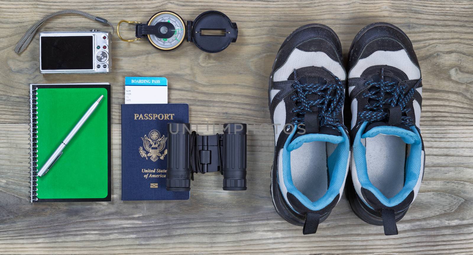 Travel gear basics on aged wooden surface