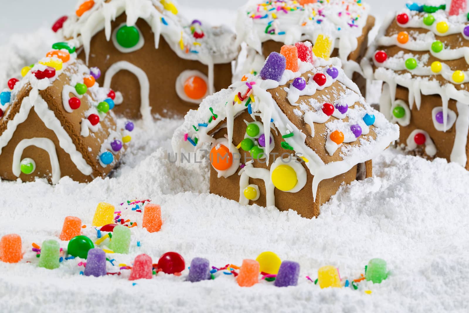 Horizontal photo of Gingerbread houses surrounded by powered snow