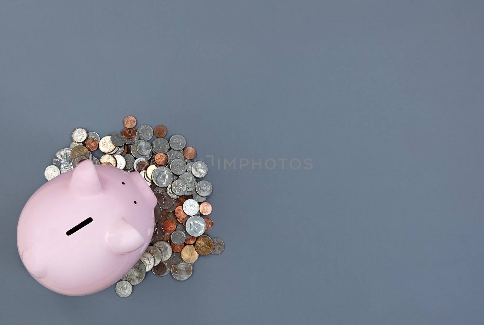 Gray desktop with piggy bank and coin currency for finance conce by tab1962