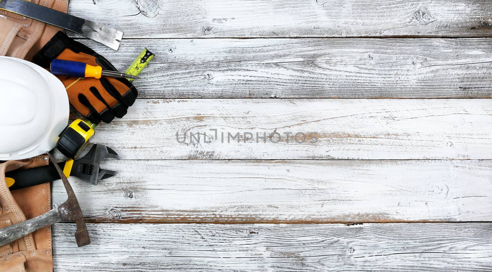 Labor Day concept with worker tools over distressed white wooden boards