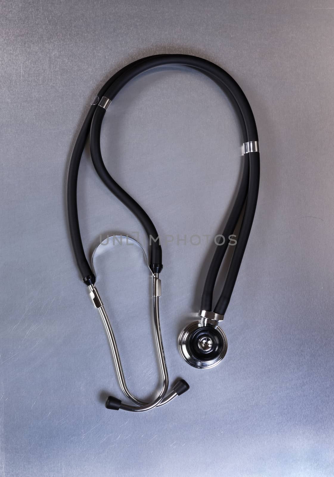 Medical stethoscope on stainless steel table in vertical layout  by tab1962