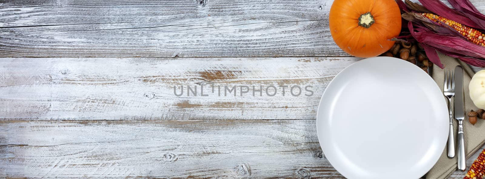 White rustic dinner table prepared for Thanksgiving celebration with copy space available 