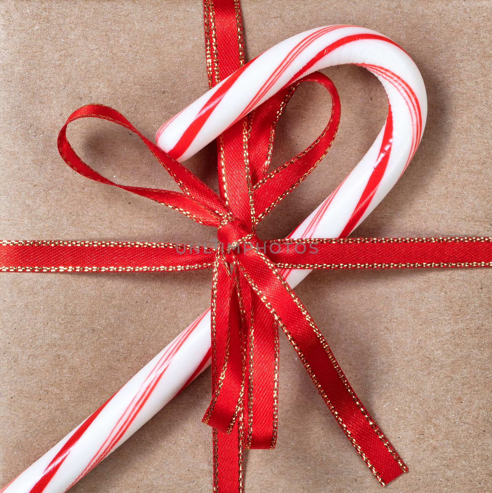 Filled frame background of Christmas gift and candy cane by tab1962