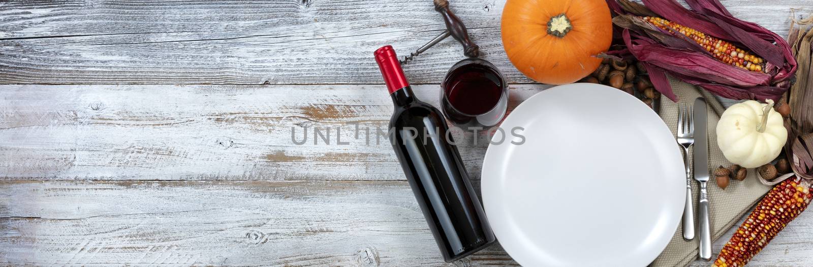 White rustic dinner table prepared for Thanksgiving meal with copy space available