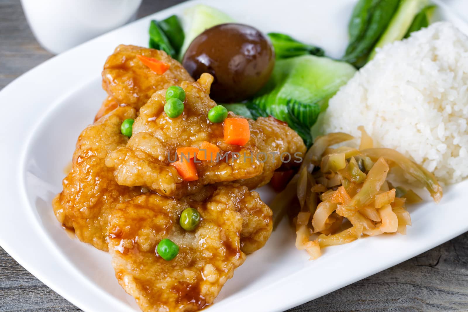 Fried fish and extras for lunch meal in white plate ready to eat by tab1962