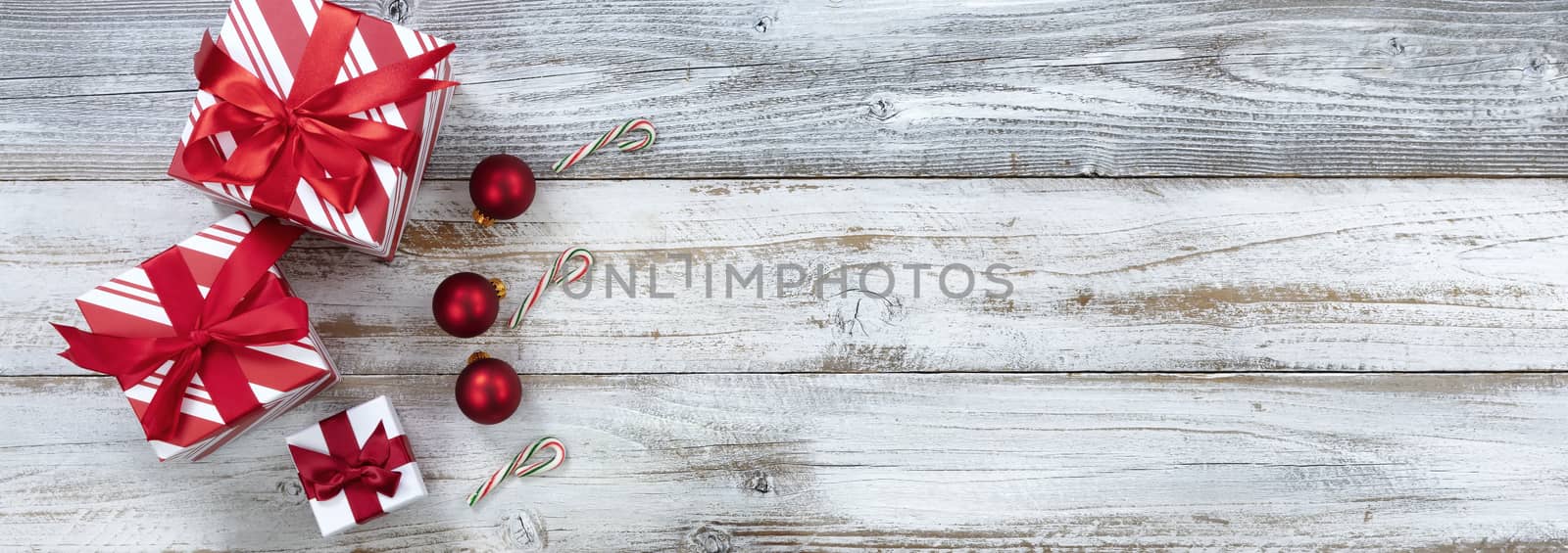 Merry Christmas with boxed gifts and ornaments on white rustic wooden background for the holiday