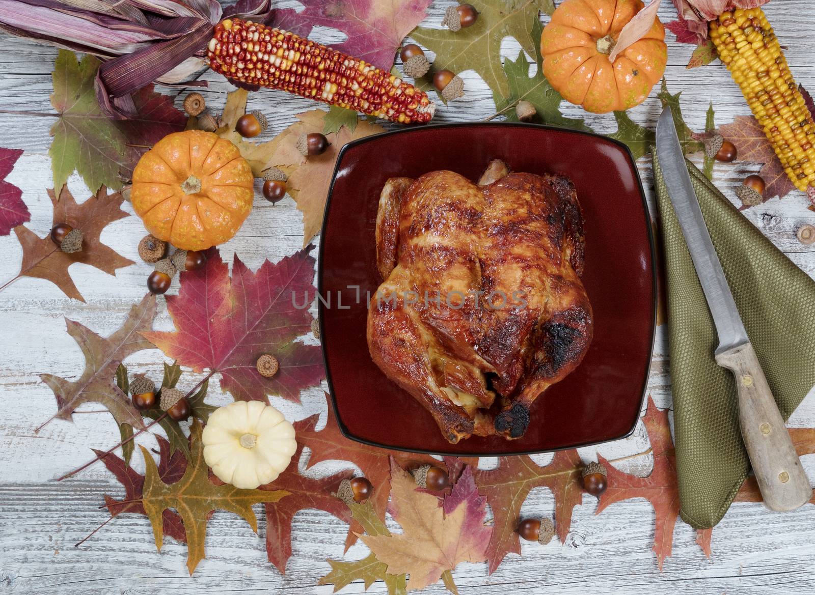 Thanksgiving turkey with autumn decorations on rustic table sett by tab1962