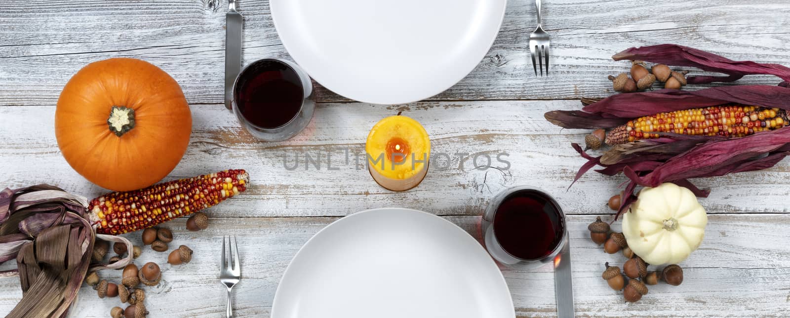 White dinner table decorated for Thanksgiving celebration by tab1962